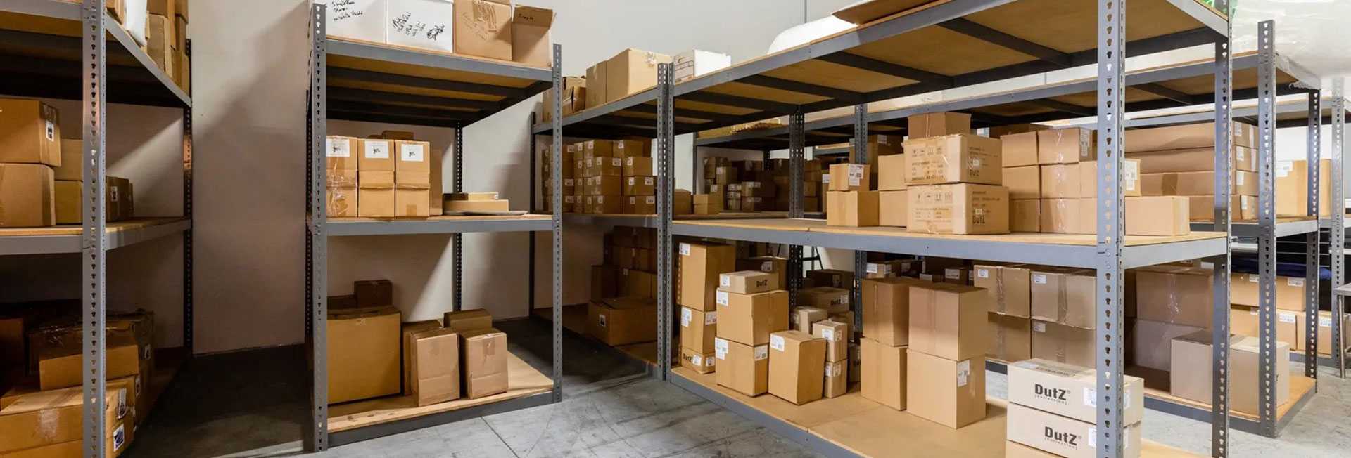 A warehouse filled with shelves and boxes of goods.